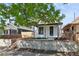 Charming home with a freshly painted exterior, inviting front porch, and landscaped yard at 3817 Osage St, Denver, CO 80211