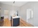 Modern kitchen island with a sleek countertop and stylish fixtures, complemented by hardwood floors at 3817 Osage St, Denver, CO 80211