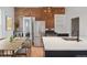 Charming kitchen with stainless steel appliances, a dining area, and exposed brick accents at 3817 Osage St, Denver, CO 80211