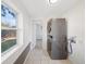 Bright laundry area with a modern, stacked washer and dryer and a window providing natural light at 3817 Osage St, Denver, CO 80211