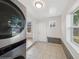 Tiled laundry room features natural lighting, modern appliances, and access to the backyard at 3817 Osage St, Denver, CO 80211