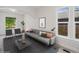 Bright living room featuring a modern sofa, neutral tones, and large windows for plenty of natural light at 3817 Osage St, Denver, CO 80211