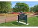 View of La Raza Park featuring a sign in a grassy area, with mature trees and construction fencing in the background at 3817 Osage St, Denver, CO 80211