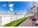 Grassy backyard with a privacy fence, patio, and outdoor grill at 5570 Perth Ct, Denver, CO 80249