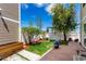 A backyard featuring healthy green grass, a wood planter, and privacy fence at 5570 Perth Ct, Denver, CO 80249