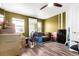 Bedroom needing organized; includes boxes, a futon, and a ceiling fan at 5570 Perth Ct, Denver, CO 80249