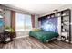 Bedroom features large windows, wall decorations, and hardwood floors at 5570 Perth Ct, Denver, CO 80249