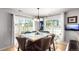 Bright dining room with large windows, hardwood floors, and seating for eight, perfect for Gathering gatherings at 5570 Perth Ct, Denver, CO 80249