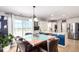 Bright dining area with wood table, leather chairs, and sliding glass doors to a deck or balcony at 5570 Perth Ct, Denver, CO 80249