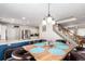 Open-concept dining area featuring a wooden table with leather chairs and a staircase in the background at 5570 Perth Ct, Denver, CO 80249