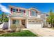 Charming two-story home featuring red shutters, a well-maintained lawn, and a spacious two car garage at 5570 Perth Ct, Denver, CO 80249
