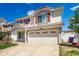 Charming two-story home featuring red shutters, a well-maintained lawn, and a spacious two car garage at 5570 Perth Ct, Denver, CO 80249