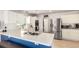 Bright kitchen featuring white cabinetry, stainless steel appliances, and a breakfast bar with blue accents at 5570 Perth Ct, Denver, CO 80249