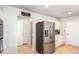 Spacious kitchen with stainless steel refrigerator, adjacent to a doorway leading to a laundry area at 5570 Perth Ct, Denver, CO 80249