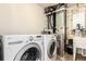 Well-equipped laundry room with LG washer/dryer, utility sink and Carrier HVAC at 5570 Perth Ct, Denver, CO 80249