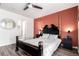 Primary bedroom showcases a four-poster bed and an ensuite bathroom entrance with a round mirror at 5570 Perth Ct, Denver, CO 80249
