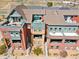 Aerial view of townhouses showing rooftop patios, neat landscaping, and modern architectural details at 5471 W 97Th Pl # E, Broomfield, CO 80020