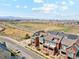 The townhouses overlook a scenic landscape featuring green spaces, a distant city skyline, and a blue sky at 5471 W 97Th Pl # E, Broomfield, CO 80020