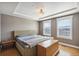 Bedroom with tray ceiling, neutral walls, and natural light from large windows at 5471 W 97Th Pl # E, Broomfield, CO 80020