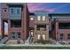 Charming townhome exterior featuring brick accents, balconies, and modern architectural details at 5471 W 97Th Pl # E, Broomfield, CO 80020