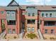 Contemporary brick townhome with landscaped front yard and steps to a covered entry at 5471 W 97Th Pl # E, Broomfield, CO 80020
