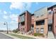 Modern multi-story townhomes showcasing brick and siding exteriors with balconies and well-maintained landscaping at 5471 W 97Th Pl # E, Broomfield, CO 80020