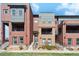 Modern townhome complex with brick and siding exteriors, balconies, and well-maintained landscaping on a sunny day at 5471 W 97Th Pl # E, Broomfield, CO 80020