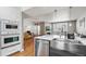 Open-concept kitchen with stainless steel appliances, modern lighting, and view to the living area at 5471 W 97Th Pl # E, Broomfield, CO 80020