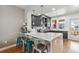 Well-lit kitchen featuring a large island, modern cabinetry, stainless steel appliances, and stylish barstool seating at 5471 W 97Th Pl # E, Broomfield, CO 80020