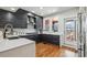 Modern kitchen featuring sleek gray cabinetry, stainless steel appliances, and hardwood floors at 5471 W 97Th Pl # E, Broomfield, CO 80020