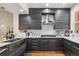 Well-equipped kitchen with gray cabinetry, quartz countertops, stainless steel hood, and modern finishes at 5471 W 97Th Pl # E, Broomfield, CO 80020