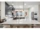Bright kitchen featuring a large island, modern cabinets, stainless steel appliances, and stylish pendant lighting at 5471 W 97Th Pl # E, Broomfield, CO 80020