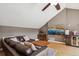A spacious living room featuring hardwood floors, a ceiling fan, and a large sofa at 5471 W 97Th Pl # E, Broomfield, CO 80020