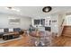 Bright, open-concept living area with hardwood floors, modern furnishings, and seamless flow between living spaces at 5471 W 97Th Pl # E, Broomfield, CO 80020