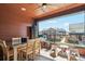 Cozy covered patio with a dining table, seating area, and views of the neighborhood at 5471 W 97Th Pl # E, Broomfield, CO 80020
