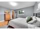 This cozy bedroom has hardwood floors, natural light and minimalist décor at 55 S Flower St, Lakewood, CO 80226