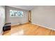 Sunlit bedroom showcases a large window and gleaming hardwood floors at 55 S Flower St, Lakewood, CO 80226