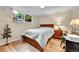 This bedroom is bright with natural light and features a wooden bed and desk at 55 S Flower St, Lakewood, CO 80226