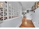 Bright entryway with decorative screen, hardwood floors and glimpses of the modern kitchen at 55 S Flower St, Lakewood, CO 80226