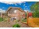 Exterior view of brick home with fenced in yard and basement access at 55 S Flower St, Lakewood, CO 80226