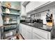 This contemporary kitchen features black counters, white cabinets, and stainless steel appliances at 55 S Flower St, Lakewood, CO 80226