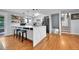 Bright kitchen with a large island, stainless steel appliances, and hardwood floors at 55 S Flower St, Lakewood, CO 80226