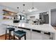 Stylish kitchen with a large island, open shelving, and modern appliances for cooking enthusiasts at 55 S Flower St, Lakewood, CO 80226
