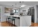 Modern kitchen with white marble counters, sleek appliances, and a large island with bar seating at 55 S Flower St, Lakewood, CO 80226