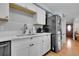 This kitchen boasts updated cabinets, stone countertops, and modern stainless steel refrigerator at 55 S Flower St, Lakewood, CO 80226