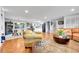Spacious living room with hardwood floors, open layout, and seamless transition to dining and kitchen at 55 S Flower St, Lakewood, CO 80226