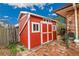 Quaint red and white storage shed with double doors, a small window, and well-kept exterior at 55 S Flower St, Lakewood, CO 80226