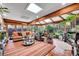 Bright sunroom featuring skylights, beamed ceilings, many windows, tile floors and lots of plants at 55 S Flower St, Lakewood, CO 80226