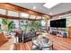 This cozy sunroom has lots of windows, beamed ceilings and is perfect for plant lovers at 55 S Flower St, Lakewood, CO 80226