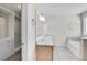 Bright bathroom featuring a double sink vanity and a walk in closet at 298 Hampstead Ave, Castle Rock, CO 80104